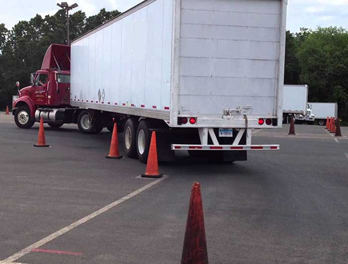 Semi truck blindside-backing into a parking space